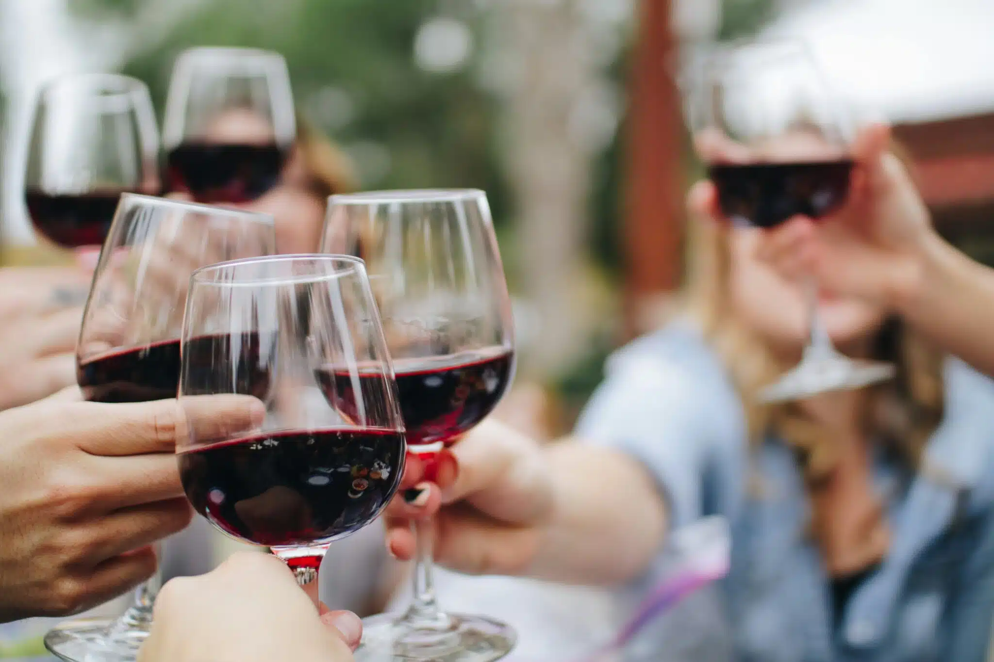 people tossing their clear wine glasses wine paris